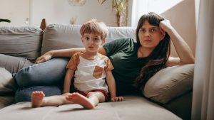 a woman and a child sitting on a couch